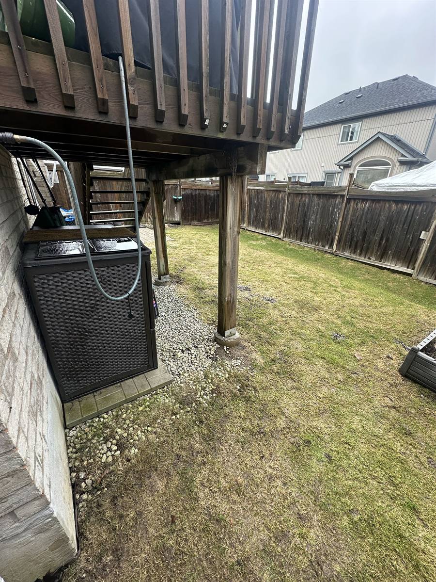 Gravel and grass under the deck before the build
