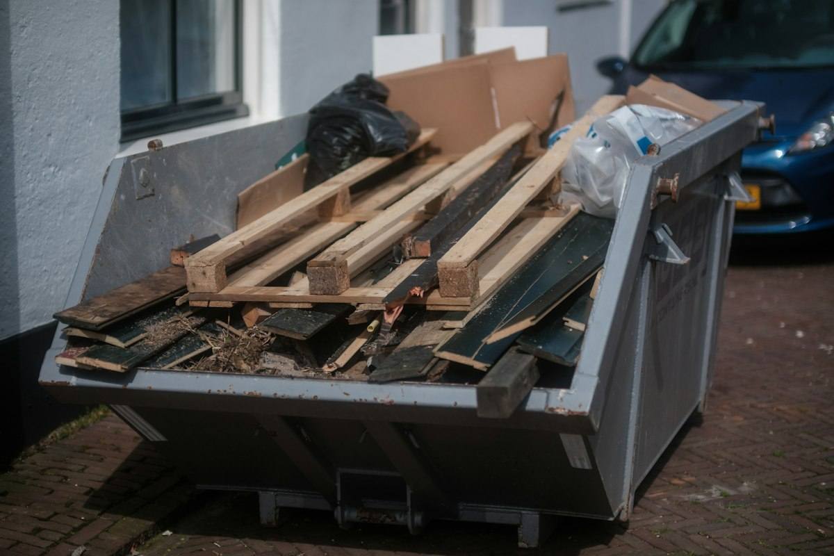 Bin loaded with wood and renovation debris