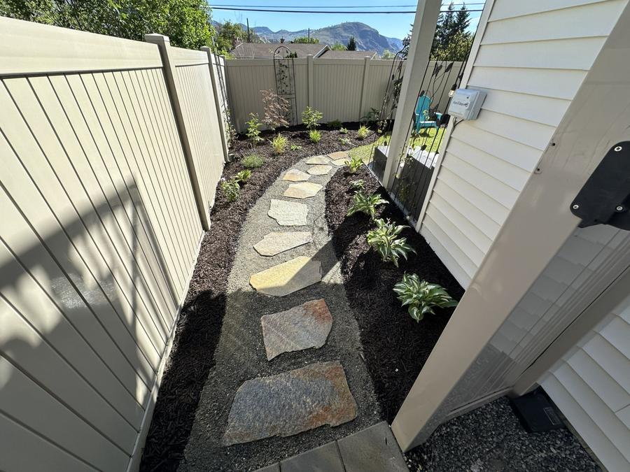 Side yard flagstone stepping stones and garden beds