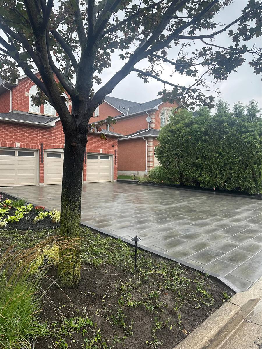 Slab driveway with a planted garden bed